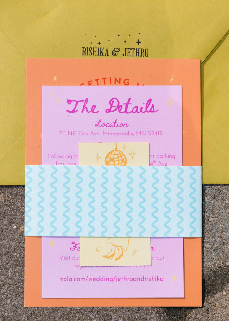 Colorful wedding invitation suite with bright pink, orange, yellow, and blue stationery designed for a playful Solar Arts Building wedding in Minneapolis, Minnesota