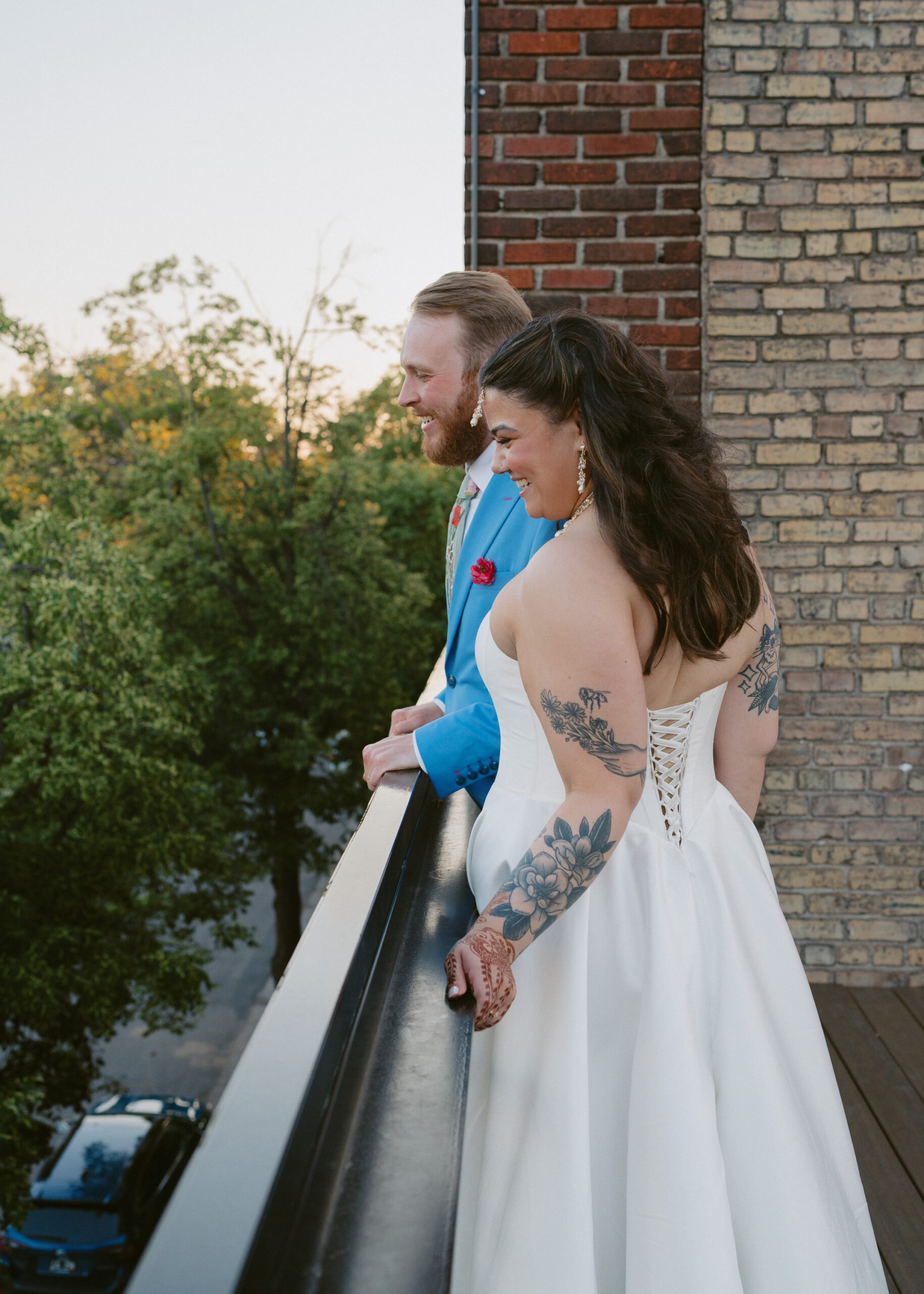 Bride and groom stand together on the rooftop balcony during sunset wedding portraits at Solar Arts Building.