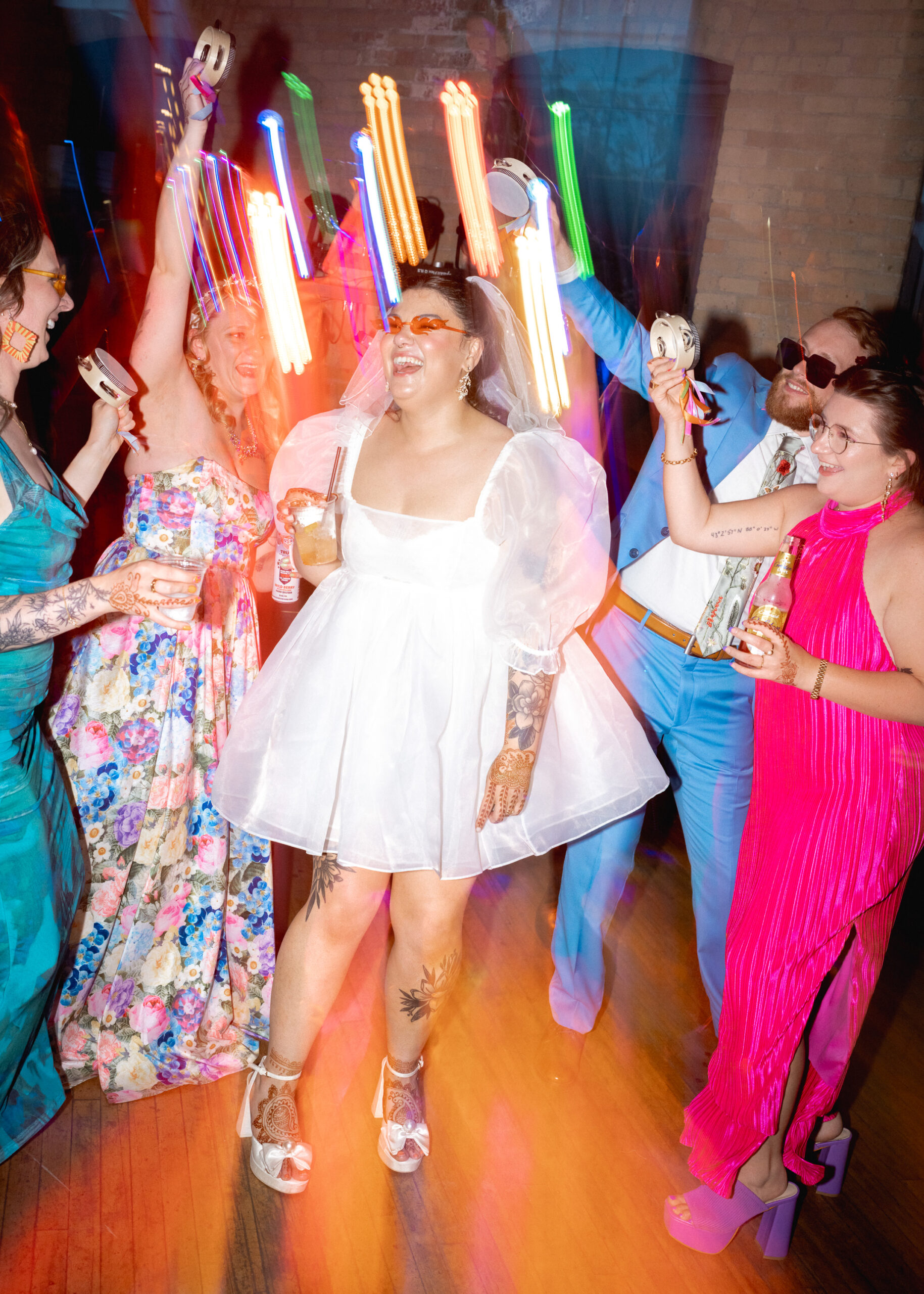 Bride celebrates with guests on the dance floor during the wedding reception at Solar Arts Building in Minneapolis.