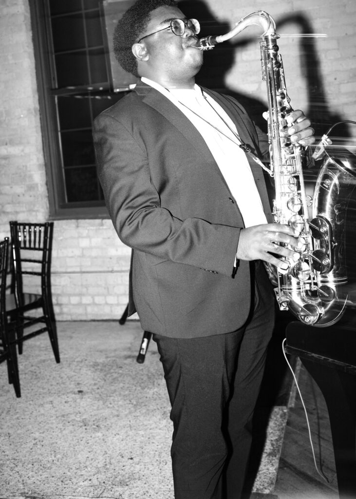 Saxophone player performs live music during the wedding reception at Solar Arts Building in Minneapolis.