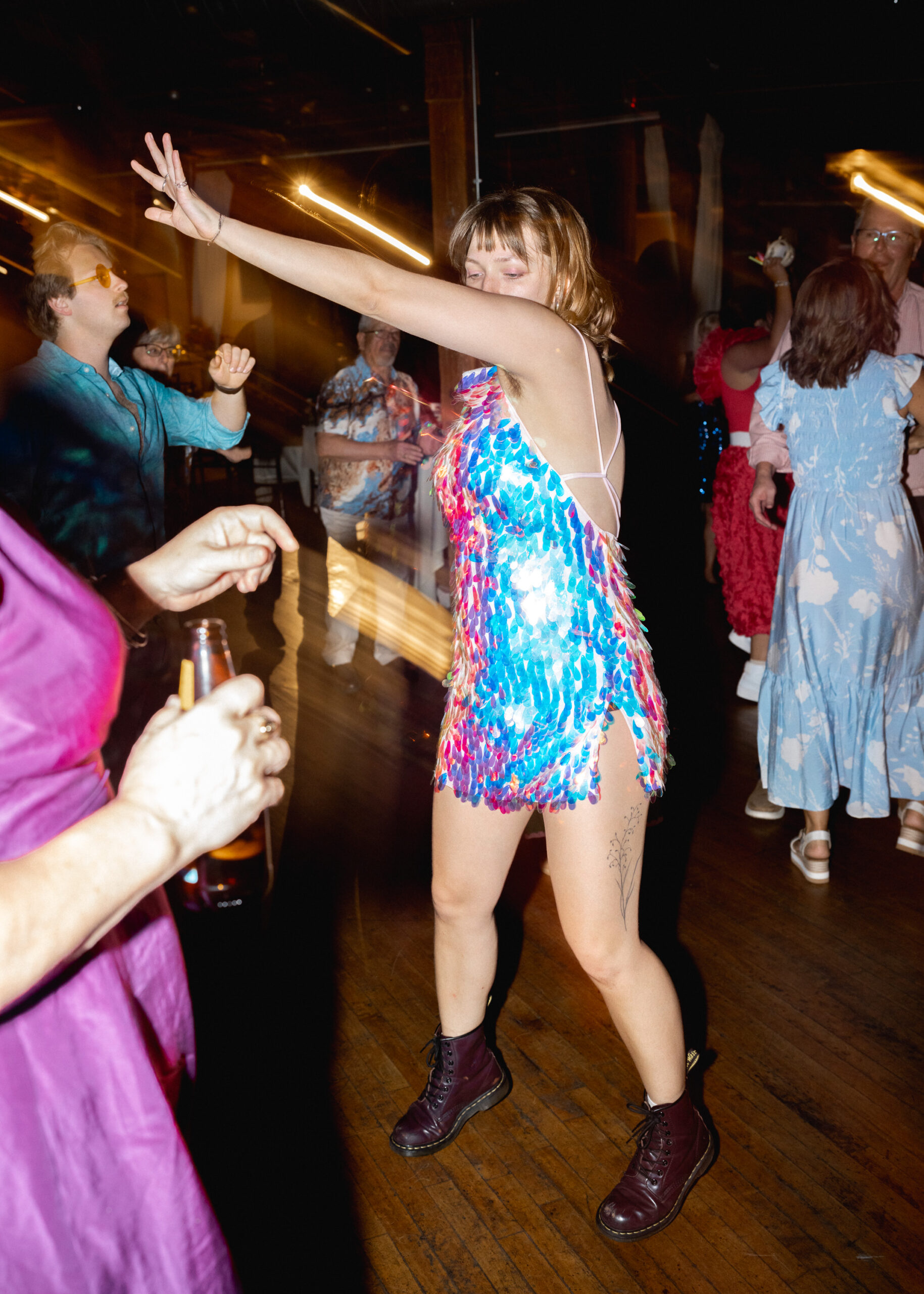 Close-up of wedding guests dancing during the lively reception at Solar Arts Building in Minneapolis.