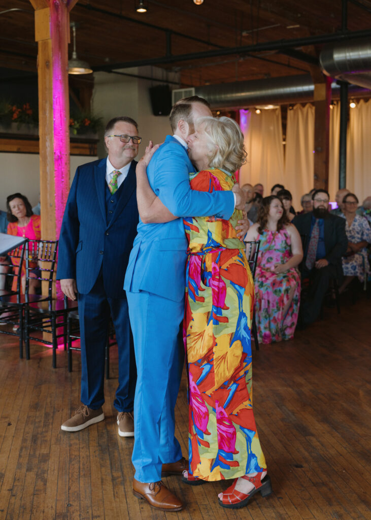 Groom embraces his mother during an emotional hug before the wedding ceremony.