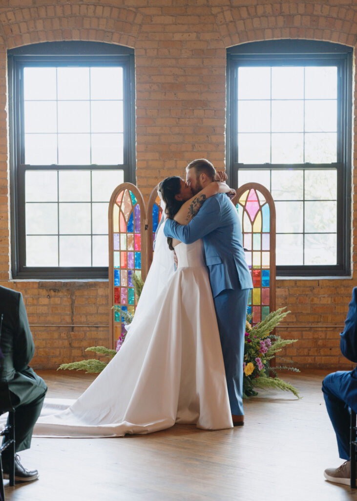 Bride and groom share their first kiss after being pronounced married.