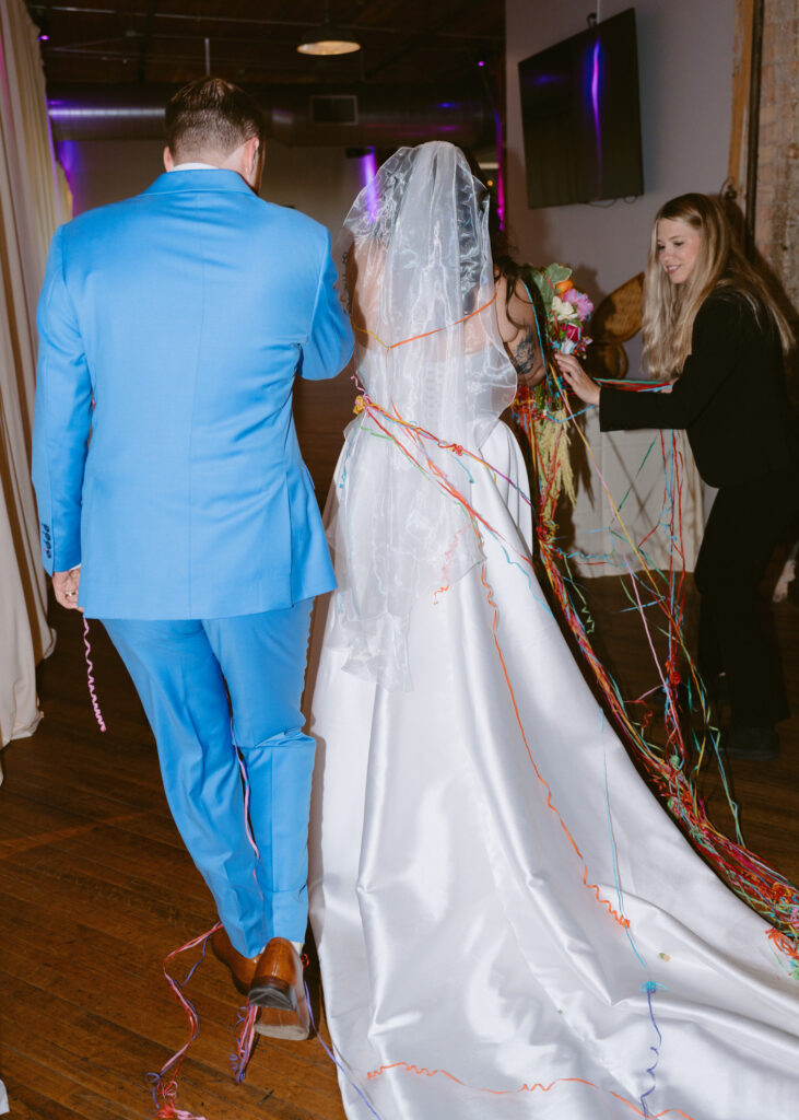 Newlyweds walk hand in hand toward their private cocktail hour after the wedding ceremony.