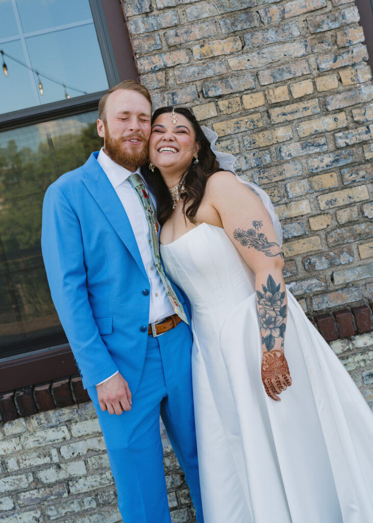 Bride and groom embracing outside during their colorful Solar Arts Building wedding in Minneapolis, Minnesota