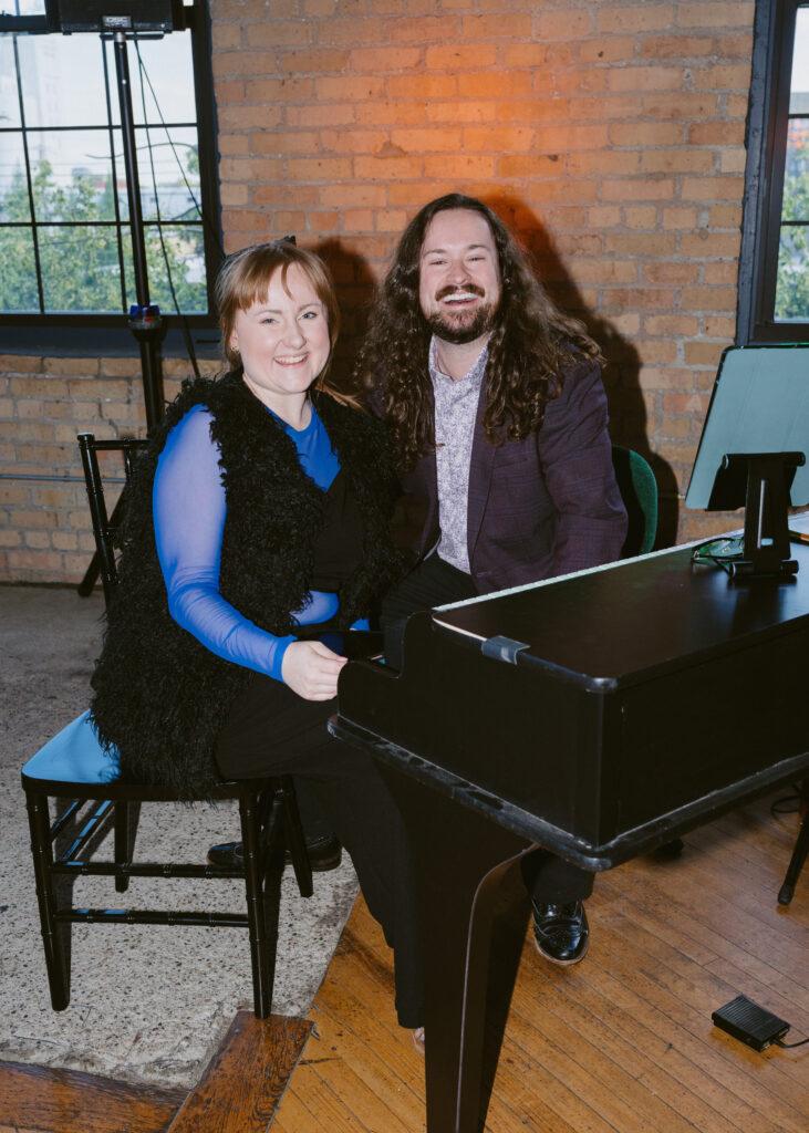 Dueling pianos performers pose together before entertaining guests during the wedding reception at Solar Arts Building in Minneapolis.
