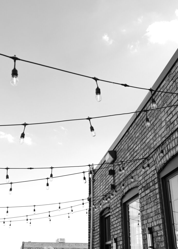 String lights stretch across the rooftop patio at Solar Arts Building during a Minneapolis wedding reception.