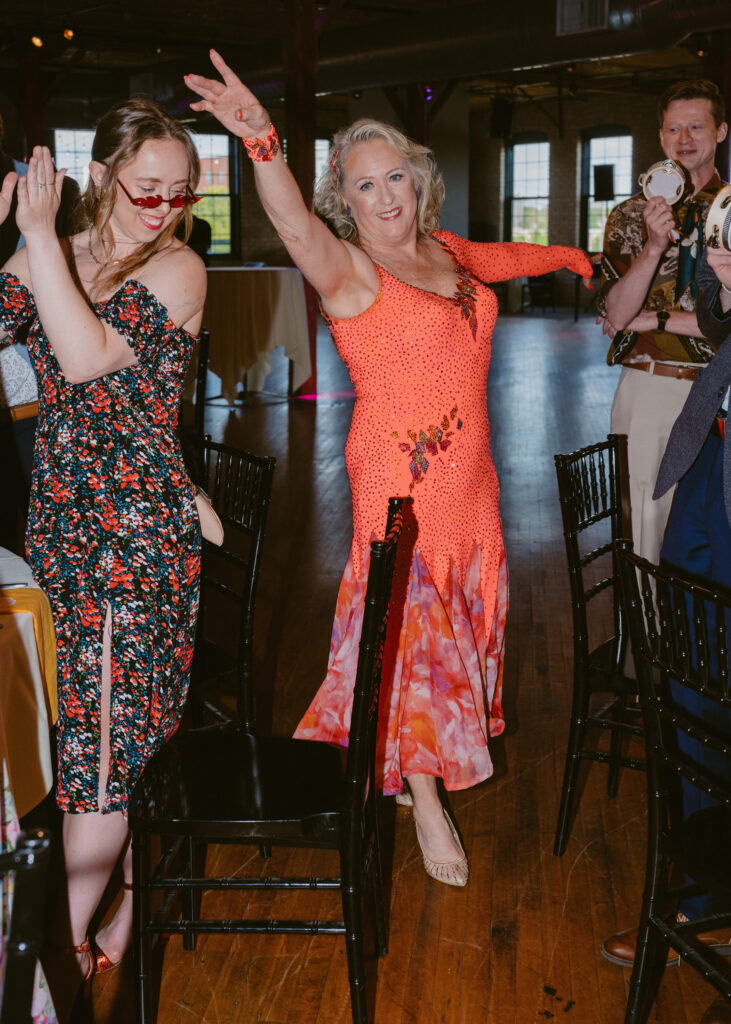 Wedding guests cheer during the best dressed contest at the reception.