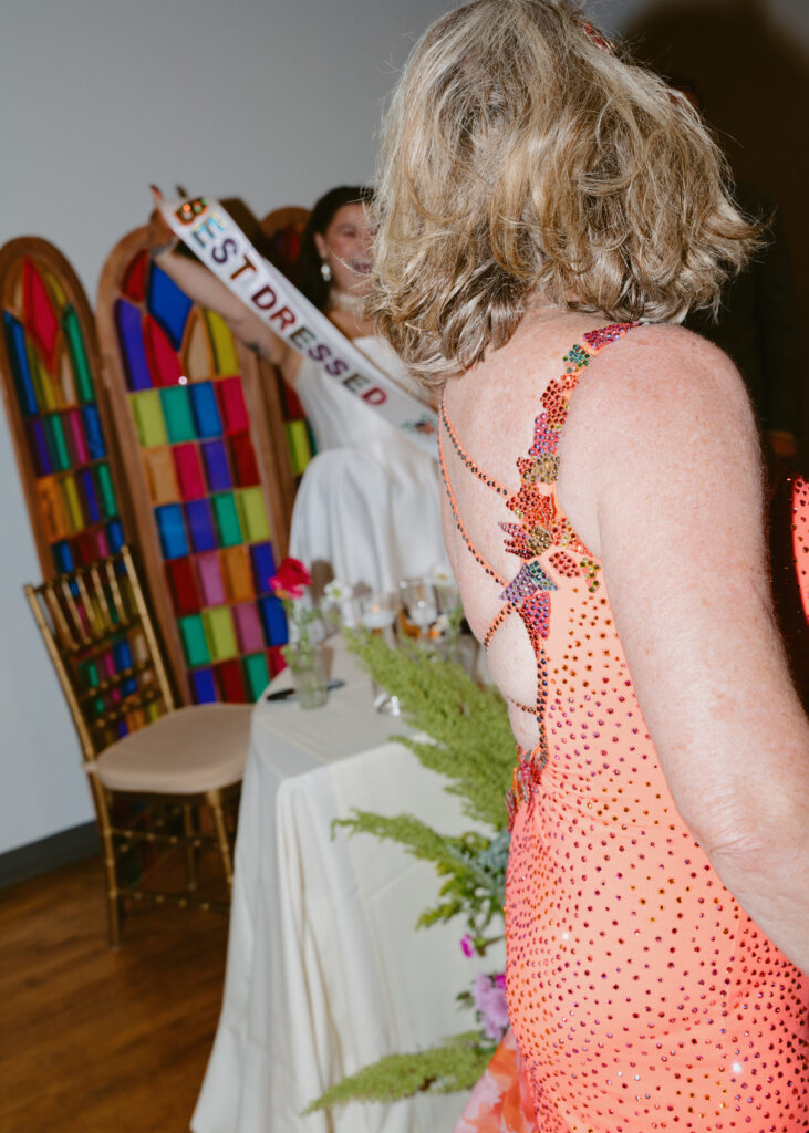 Wedding guests cheer during the best dressed contest at the wedding reception.