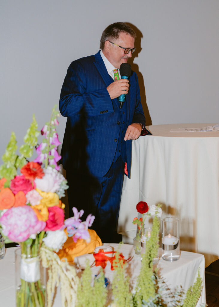 Groom’s father gives a heartfelt speech during the wedding reception at the Solar Arts Building.