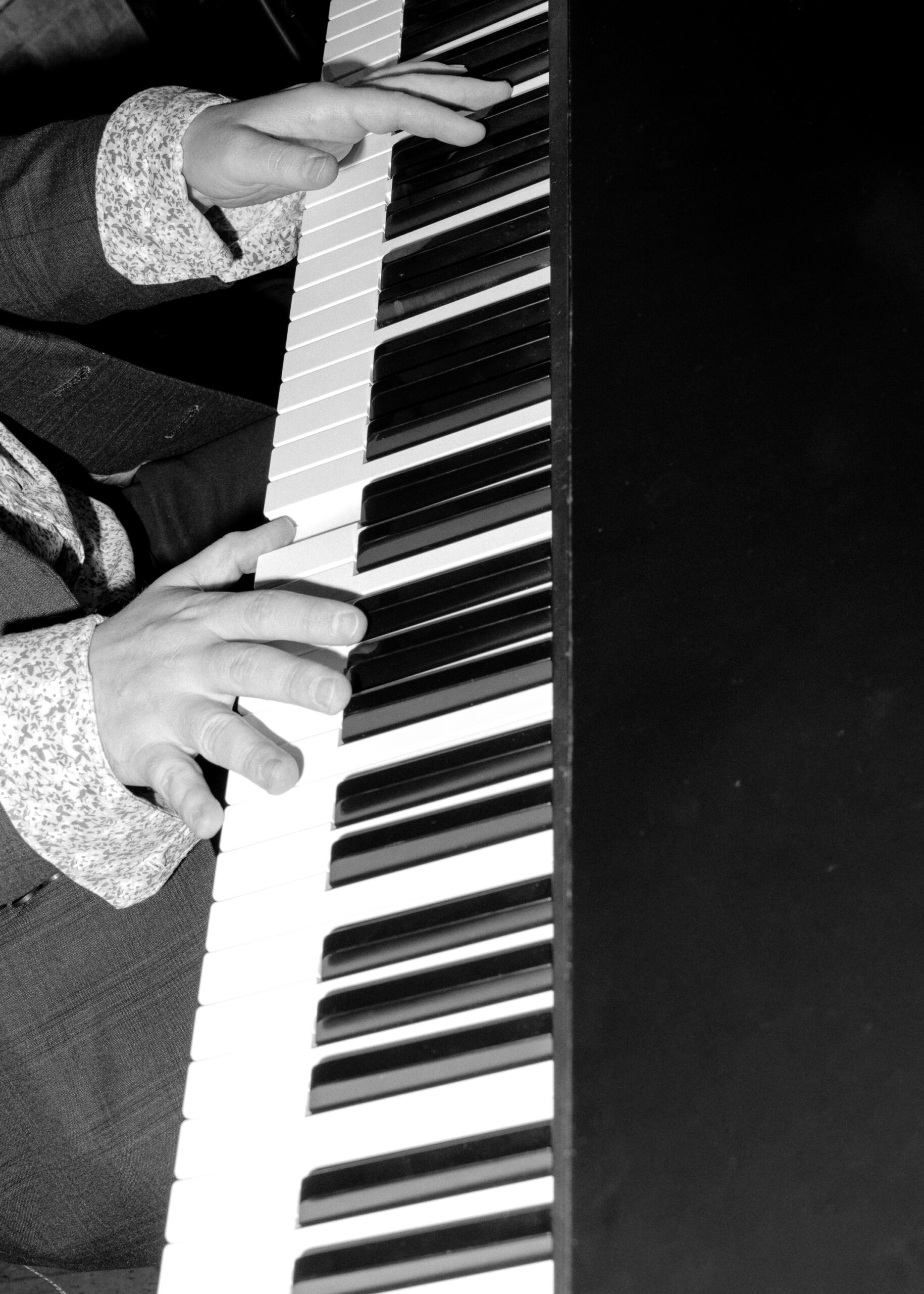 Close-up of a pianist’s hands playing during the wedding reception at Solar Arts Building in Minneapolis.